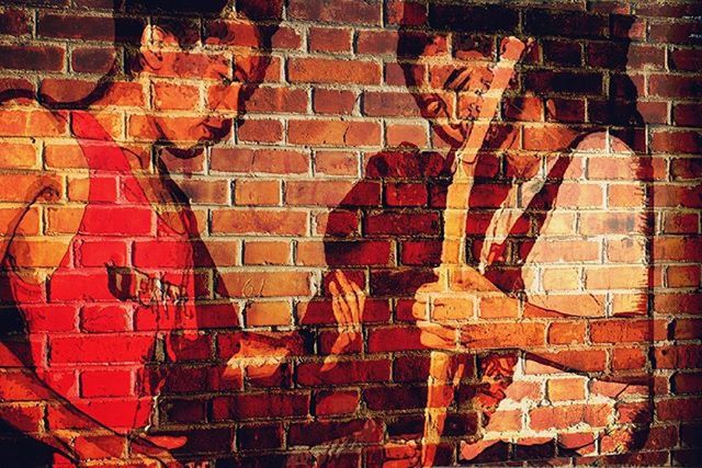 brick wall, wall - building feature, art and craft, creativity, graffiti, art, built structure, architecture, building exterior, human representation, wall, animal representation, outdoors, red, no people, orange color, day, full frame, street art