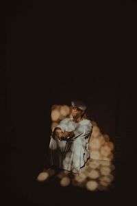 Close-up of a young couple sitting in the dark