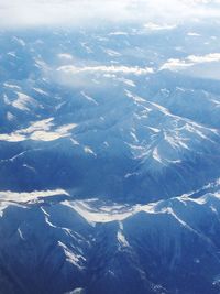 Aerial view of snowcapped mountains against sky