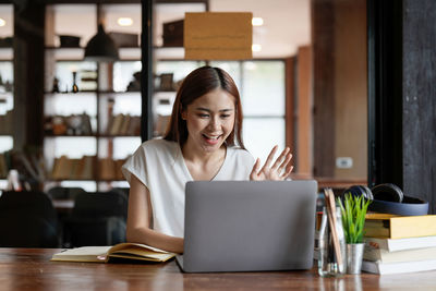 Young woman using laptop while sitting at home