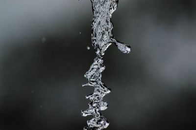 Close-up of water splashing against black background