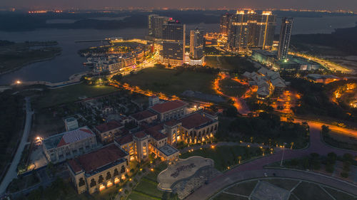 High angle view of illuminated buildings in city at night