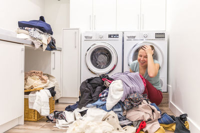 Portrait of smiling woman at laundromat