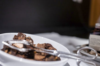 Close-up of chocolate cake pieces in bowl on counter at ski resort