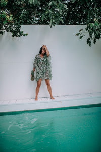 Woman standing in swimming pool