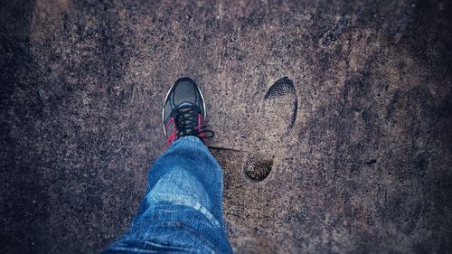 Low section of man standing on ground