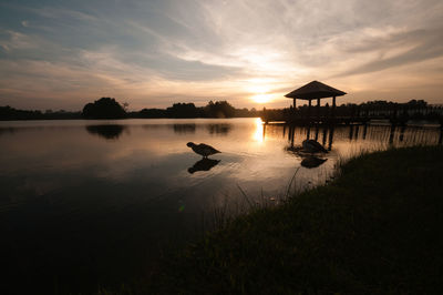 Scenic view of lake against sky during sunset