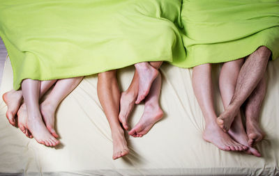 Low section of people in bed