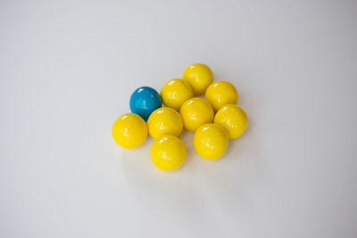 Close-up of multi colored balloons over white background