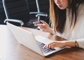 Woman using laptop on table