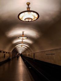 People at illuminated railroad station