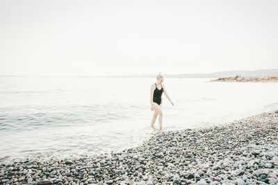 Full length of woman standing at beach