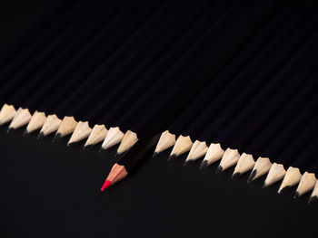 High angle view of colored pencils against black background