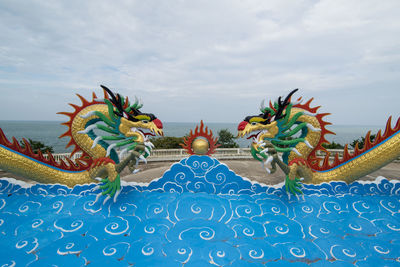 Low angle view of sculpture against blue sky