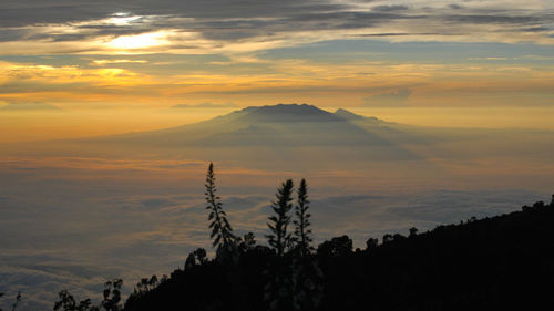 Scenic view of silhouette mountains against sky at sunset