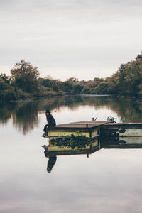 Man on lake against sky