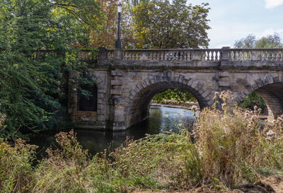 Arch bridge over river in forest