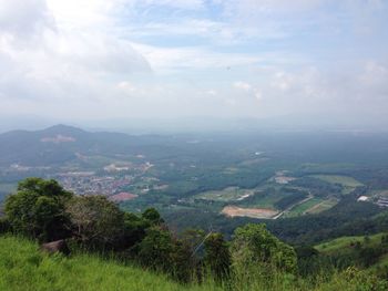 Scenic view of landscape against cloudy sky