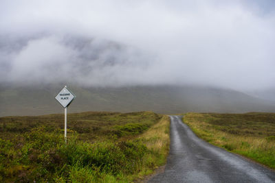 Road passing through landscape against sky