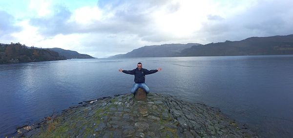Portrait of man in lake against sky