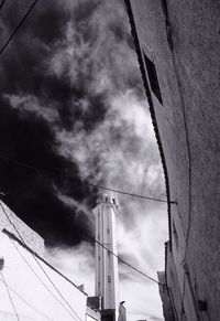 Low angle view of building against cloudy sky