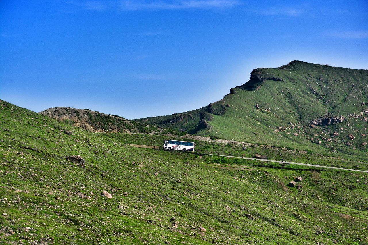 mountain, grass, landscape, tranquility, tranquil scene, blue, scenics, mountain range, clear sky, beauty in nature, green color, nature, field, non-urban scene, sky, grassy, hill, remote, copy space, countryside