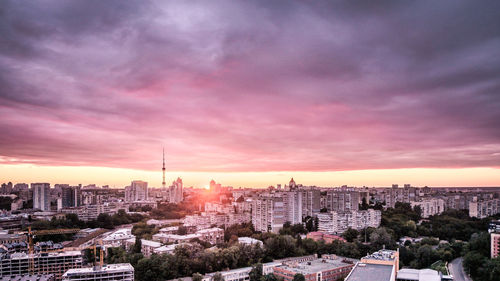 View of cityscape against cloudy sky