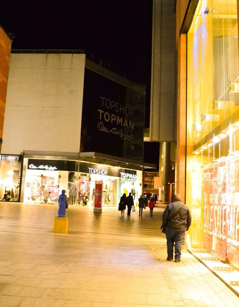 architecture, built structure, men, walking, text, building exterior, illuminated, person, city, city life, lifestyles, western script, full length, large group of people, non-western script, communication, building, street, night