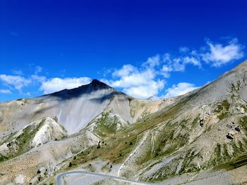 Scenic view of mountains against blue sky