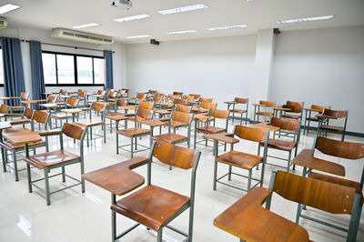 Empty chairs and tables in classroom