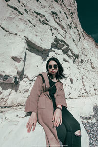 Portrait of young woman on rock