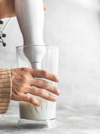 Midsection of woman pouring coffee in cup