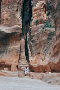 Man sitting against cliff