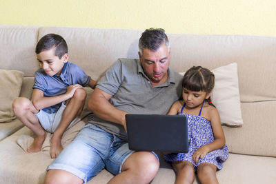 Father with children doing homework at home
