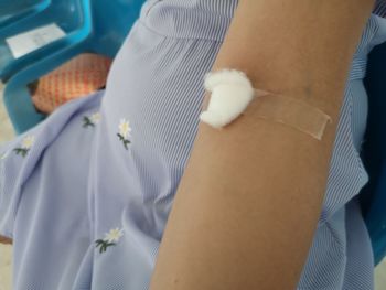 Close-up of man standing by car