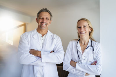 Portrait of confident male and female doctor