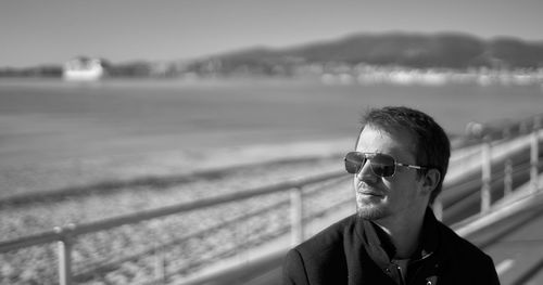 Portrait of young man wearing sunglasses standing outdoors