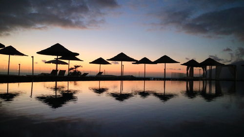 Tourist resort swimming pool at sunset