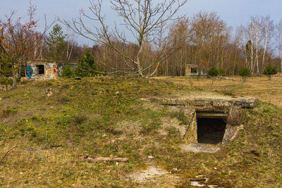 Abandoned house on field against sky