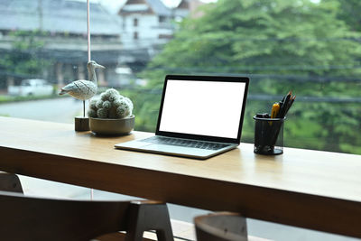 Table and woman using laptop