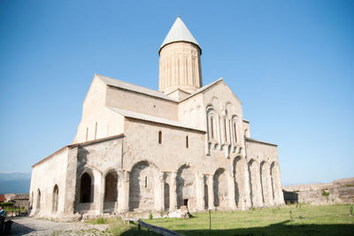 Low angle view of historical building against clear blue sky