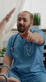 Male nurse talking with patient at clinic