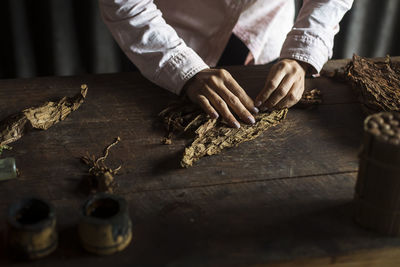 Midsection of man preparing food on table