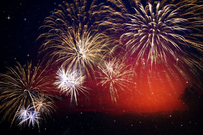 Low angle view of firework display at night