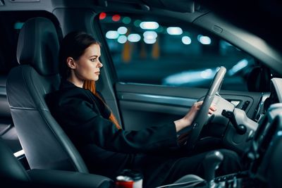 Young woman sitting in car