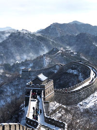Aerial view of great wall of china during winter against sky