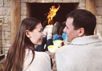 Young couple holding ice cream outdoors
