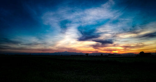 Scenic view of field against sky during sunset