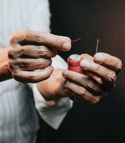 Midsection of man holding cigarette