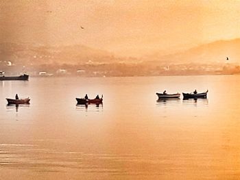 Silhouette boat on sea against sky during sunset